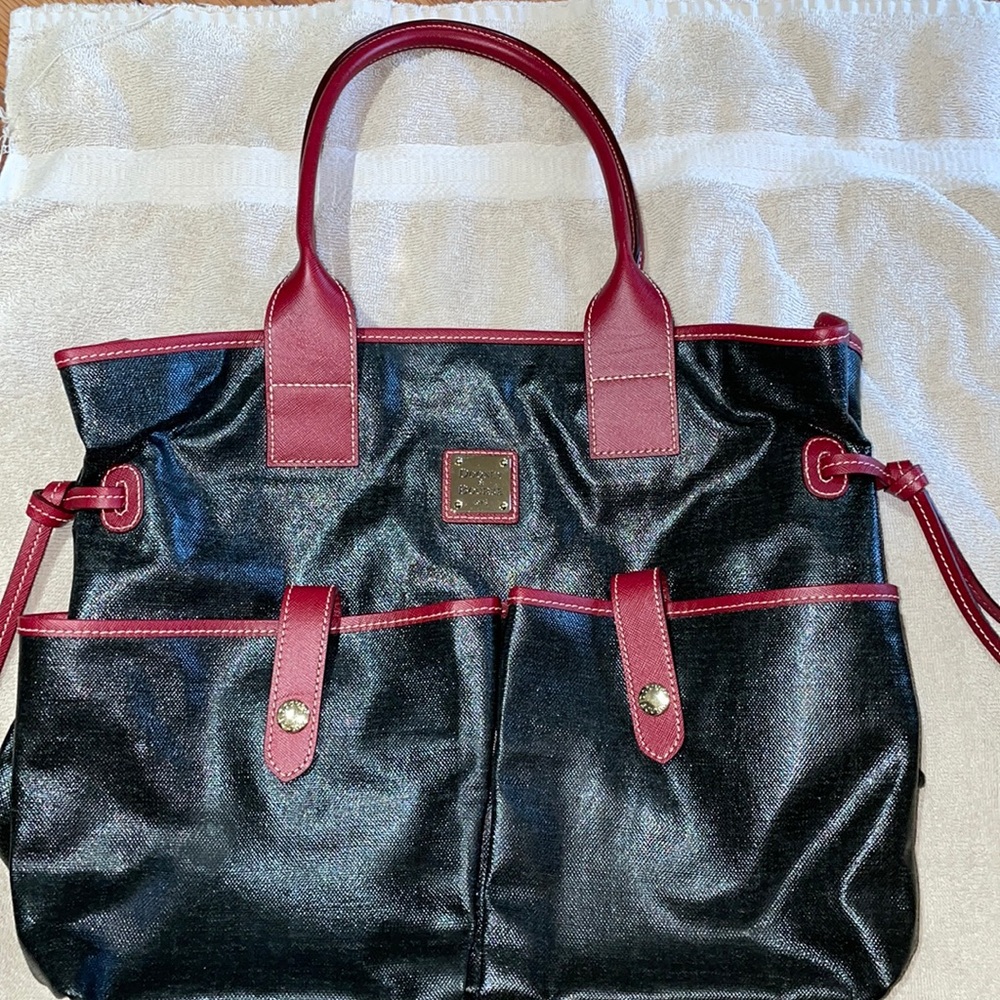 Dooney and Bourne Black leather handbag with red trim.